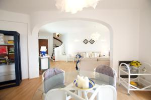 a dining room and living room with a glass table and chairs at T3 Holiday Cottage near the beach | B111 in Porches