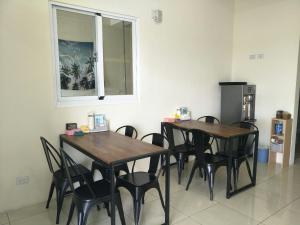 a dining room with two tables and black chairs at 豪民宿編號1410 in Taitung City