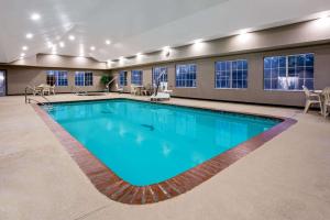 a large pool with blue water in a building at La Quinta by Wyndham Conroe in Conroe