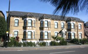 a large brick building on the side of a street at Westciti Croydon Serviced Apartments in Croydon