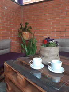 a table with two coffee cups on top of it at Hotel-restaurant complex S Legkim Parom in Brovary