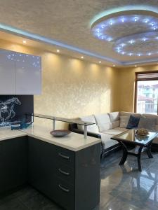 a living room with a couch and a table at Obzor Tatyana Apartaments Nemo in Obzor