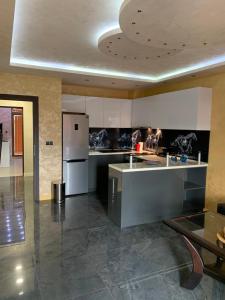 a kitchen with a refrigerator and a counter top at Obzor Tatyana Apartaments Nemo in Obzor