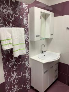 a bathroom with a sink and a mirror at Obzor Tatyana Apartaments Nemo in Obzor +10 photos
