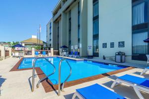 The swimming pool at or close to Comfort Inn & Suites Durham near Duke University