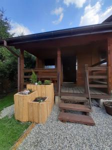 a log cabin with a porch and a deck at Siedlisko Bieszczadzkie 1 in Lutowiska