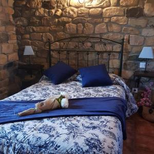 a bed with a stuffed animal laying on it at Casa Rural Juntana in Abionzo