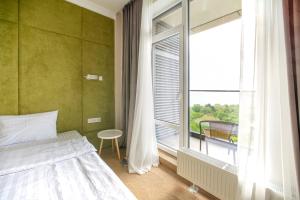 Ένα ή περισσότερα κρεβάτια σε δωμάτιο στο Apart hotel Greenwood near Sea +56 φωτογραφίες