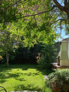 a backyard with a yard with grass and a tree at Villa Lisa in Diano Marina