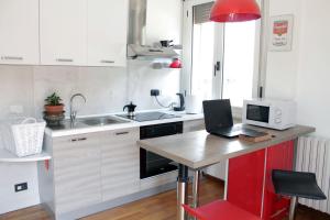 a kitchen with a desk with a laptop on it at casa Lago di Garda in Garda