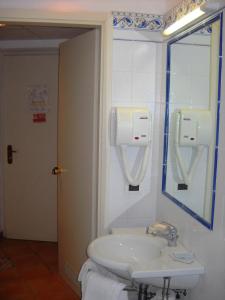a bathroom with a sink and a mirror at Hotel Club San Diego in Maratea