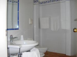 ein weißes Bad mit einem Waschbecken und einem WC in der Unterkunft Hotel Club San Diego in Maratea