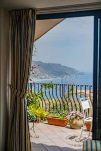 a view of a balcony with a view of the ocean at Old Memories House in Taormina