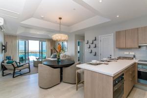 - une cuisine et un salon avec un îlot de cuisine et une table dans l'établissement Rose Quartz Condo Suite Grenada, à Egmont