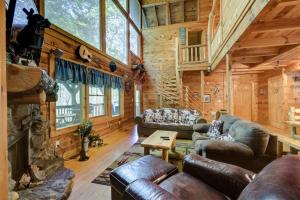 a living room with leather furniture in a log cabin at A Rustic Elegance #4 in Sevierville