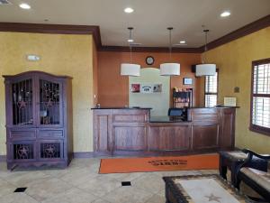 a large room with a wine bar in a building at Eagle Ford Inn in Floresville