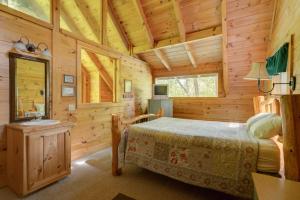 a bedroom with a bed in a wooden cabin at Whispering Pines #33 in Sevierville +16 photos