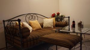 um sofá com almofadas e uma mesa num quarto em Хотел-Ресторант Тиролиа em Gorna Oryakhovitsa