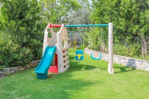 a playground with a slide in a yard at Sergios in Koukounaries