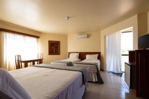 Postel nebo postele na pokoji v ubytování Canzi Cataratas Hotel + 37 fotografií