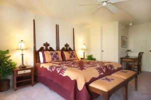 a bedroom with a large bed and a ceiling fan at The Cliffs Club at Princeville in Princeville