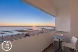 a room with a balcony with a view of the beach at Dom Jose Beach Hotel (Plus) in Quarteira