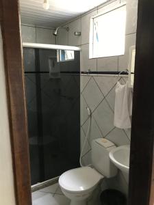 a bathroom with a toilet and a sink at Pousada Mar Aberto in Salvador