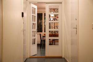 a hallway with white doors and a dining room at Tehtaan Hotelli in Karkkila