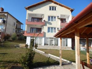 a large white building with a yard in front of it at Balabanovata Kashta in Ivaylovgrad