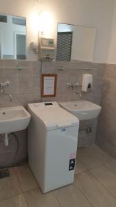 a bathroom with two sinks and a mirror at Apartmani Paron Šime in Seline +36 photos