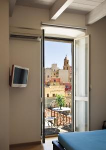 a bedroom with a sliding glass door with a view of the city at Marina Di Castello in Cagliari