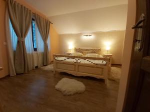 普雷代亞爾的住宿－Vila Piscul Ursului，一间卧室配有一张带两盏灯的床和一扇窗户。