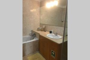a bathroom with a sink and a tub and a mirror at Lavra Sea & Sun Beach Apartment (up to 4 guests) in Lavra +21 photos