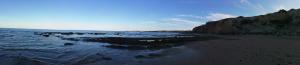 a view of a beach with rocks in the water at Hostal Brisas de Conil in Conil de la Frontera