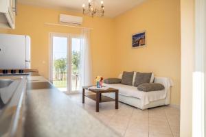 a living room with a couch and a table at Botzoris Apartments in Sidari