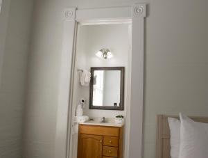 a bathroom with a sink and a mirror at Duval House in Key West