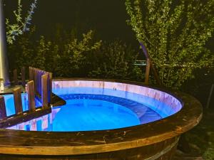a hot tub in a barrel at night at Zen Garden in Oradea +37 photos