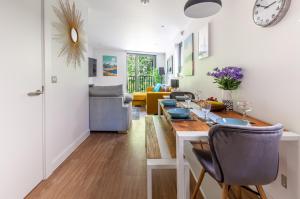 a dining room and living room with a table and chairs at Castle View Luxury 1 Bed Apartment in Edinburgh