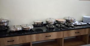 a group of pots and pans on a stove in a kitchen at Lit Suites in Abuja