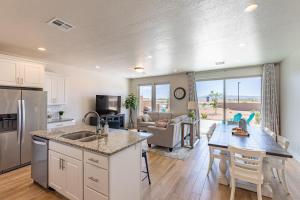 a kitchen and living room with a table and a counter at Pleasant View in St. George