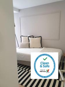 a bed with a sign that says clean and safe at Casa do Museu, Museum House in Coimbra