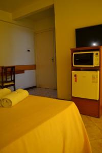 Tempat tidur dalam kamar di Hotel Scala