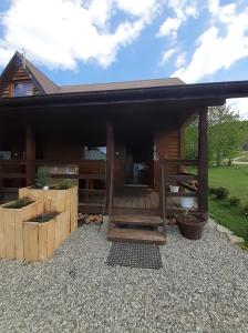 a house with a porch and a patio at Siedlisko Bieszczadzkie 3 in Lutowiska