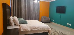 A bed or beds in a room at TERTIUS LODGE