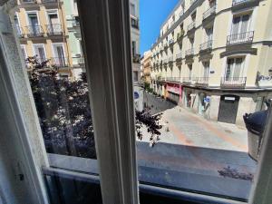 a view from a window of a street with buildings at Plaza Dort Rooms IV in Madrid