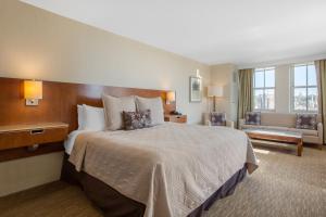 a hotel room with a large bed and a large window at Omni Providence in Providence