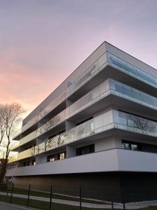 a white building with a lot of windows at Natural Hel Apartamenty in Hel