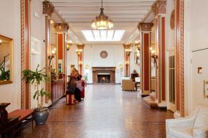 a woman sitting in a hallway in a building at Cardinal Hotel in Palo Alto