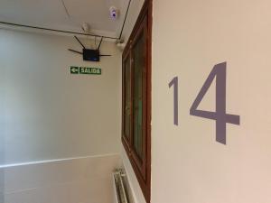 a bathroom with a number forty four on the wall at CH Plaza D'Ort Rooms Madrid in Madrid