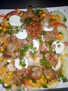 a plate of food with beans beans and vegetables at Lit Suites in Abuja